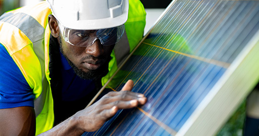 Contractor inspecting solar panel 