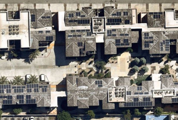 aerial view of apartment building with solar panels