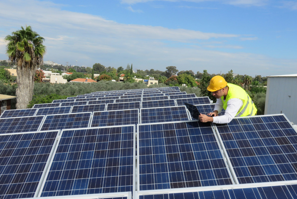 A SOMAH contractor checking a solar panel system installation