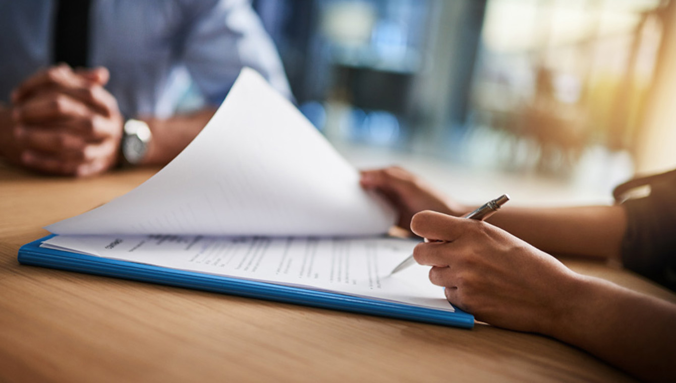 a person signing document papers