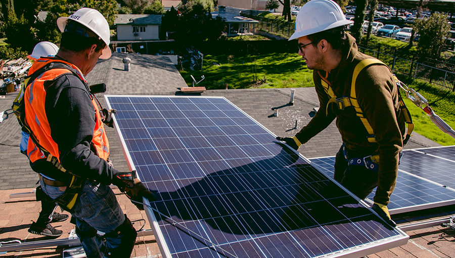two workers handling a PV system